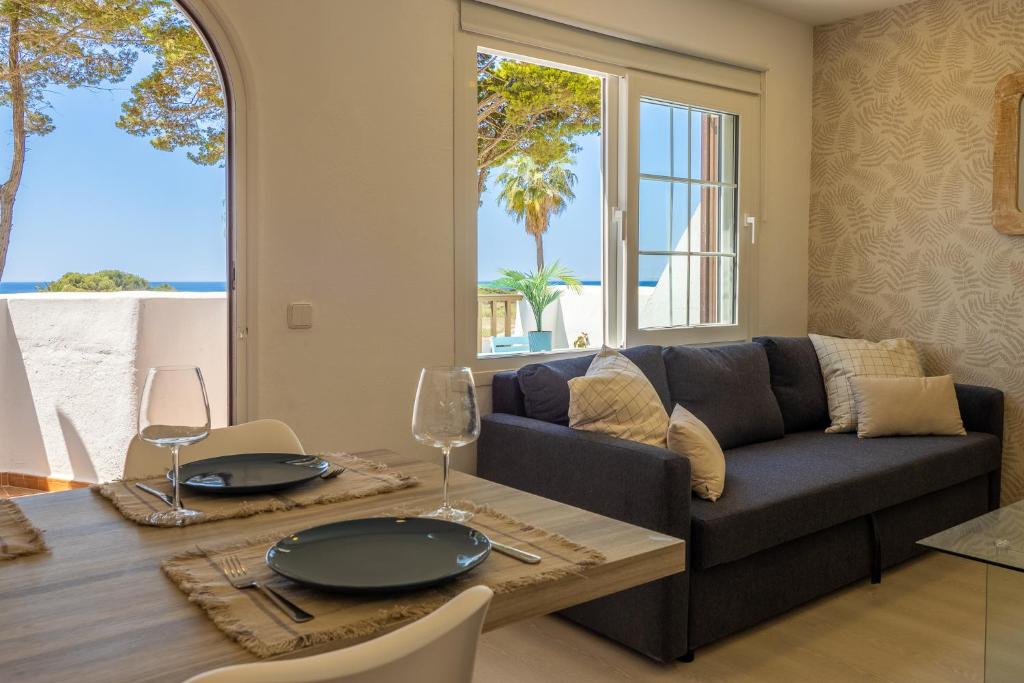 a living room with a couch and a table at Preciosos Apartamentos Reformados en Son Bou in Son Bou