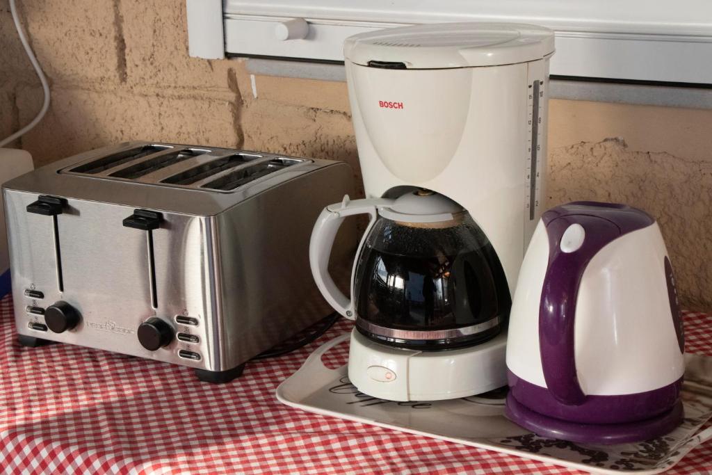 a blender and a toaster sitting on a table at Villa Bel Passo Apartments in Kefalos