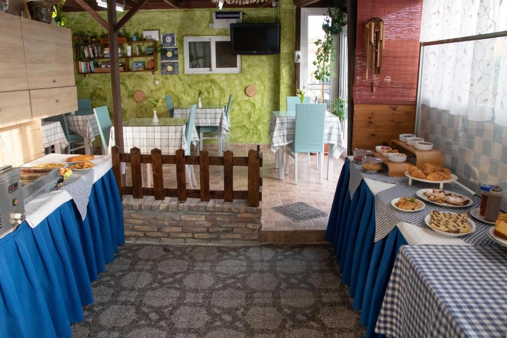 a buffet line with blue tables with food on them at Villa Bel Passo Apartments in Kefalos