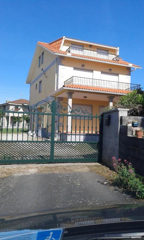 a house with a fence in front of it at Novas Foxos (Ático) in A Lanzada