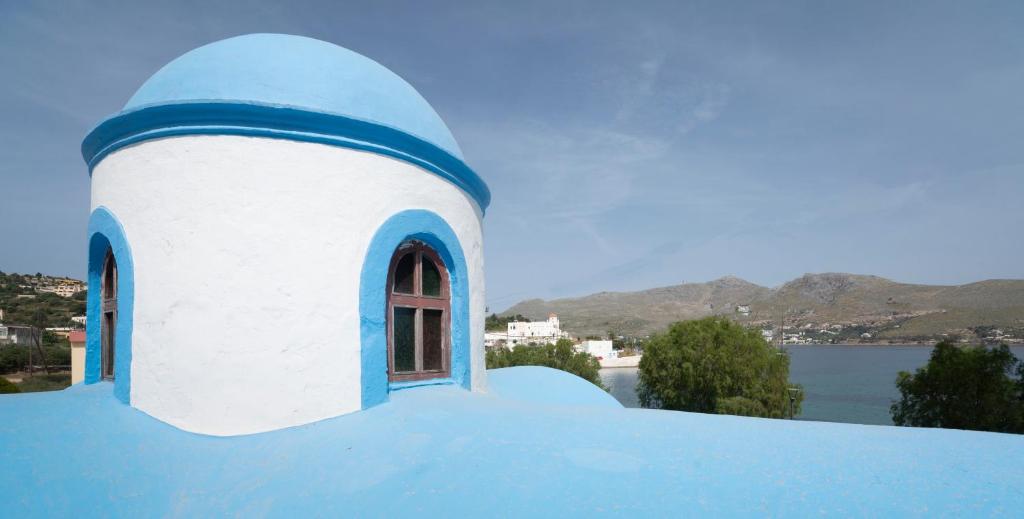 a blue and white building with a window at Tassos Apartments I in Alinda