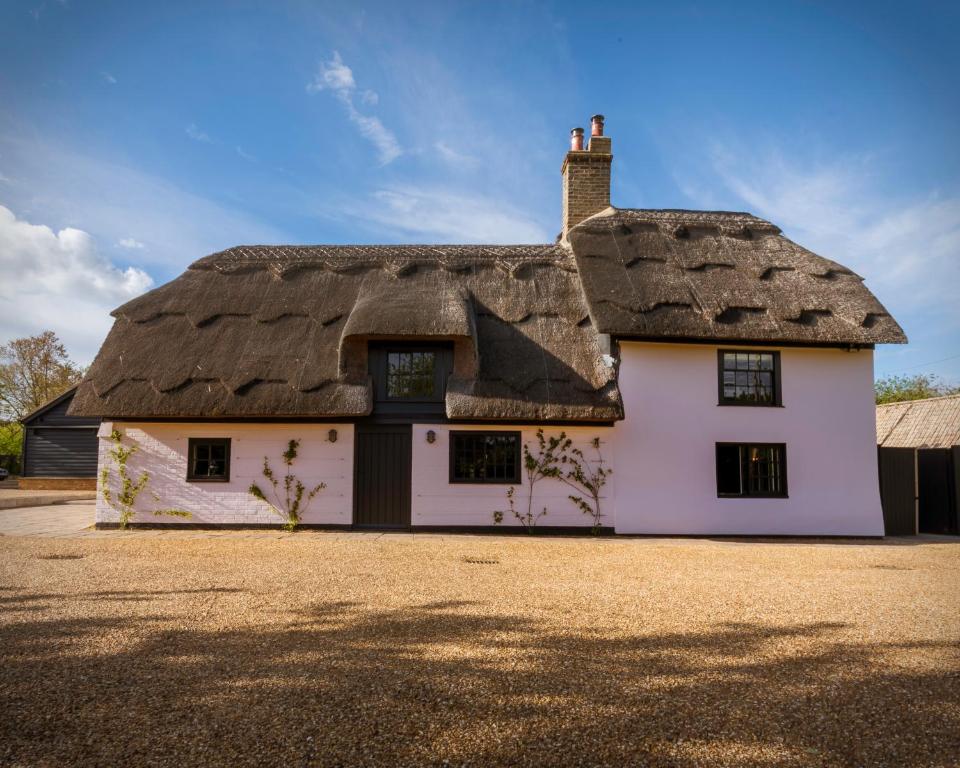 a thatched house with a thatched roof at The Elm 