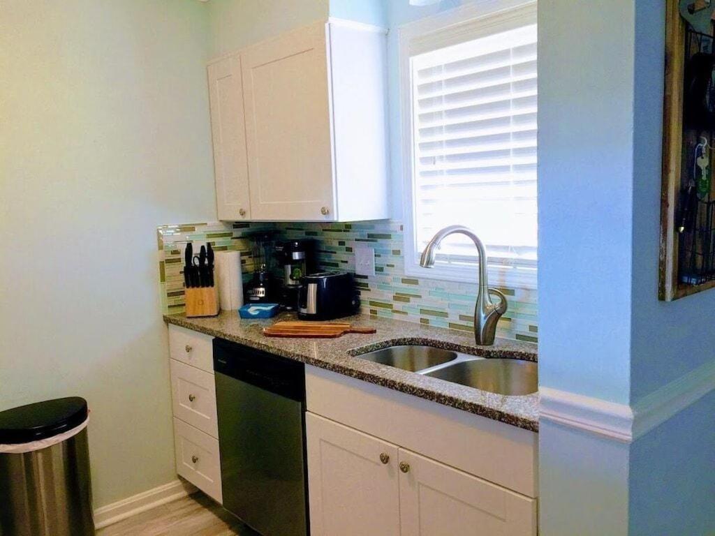 a kitchen counter with a sink and a window at Beach Harbour 17 at the CB Boardwalk Walk to everything! in Carolina Beach