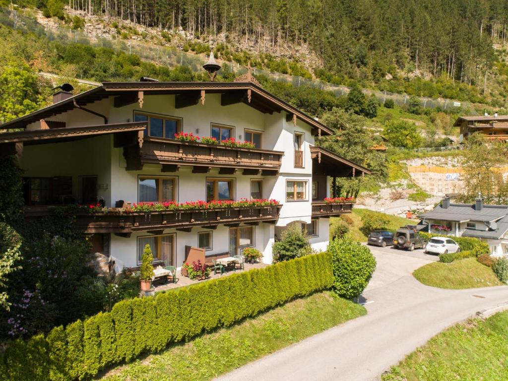 a house in the mountains with flowers on the balconies at Ferienhaus Oblasser I in Finkenberg