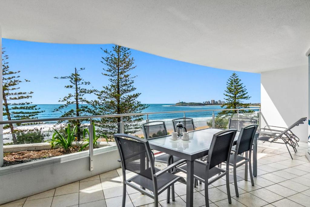 a table and chairs on a balcony with a view of the ocean at Sirocco 507 by G1 Holidays in Mooloolaba