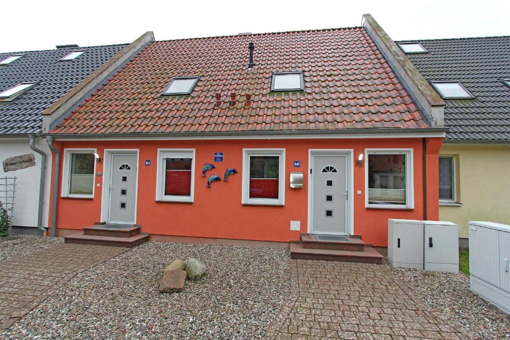 PruchtenにあるFerienhaus Pruchten FDZ 311の白い扉と瓦屋根の赤い家