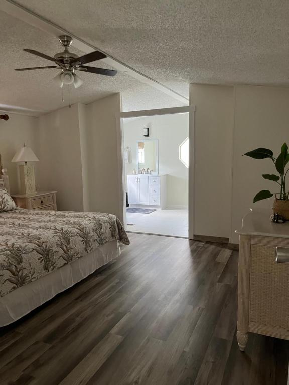 a bedroom with a bed and a ceiling fan at Hogarth in Beaufort