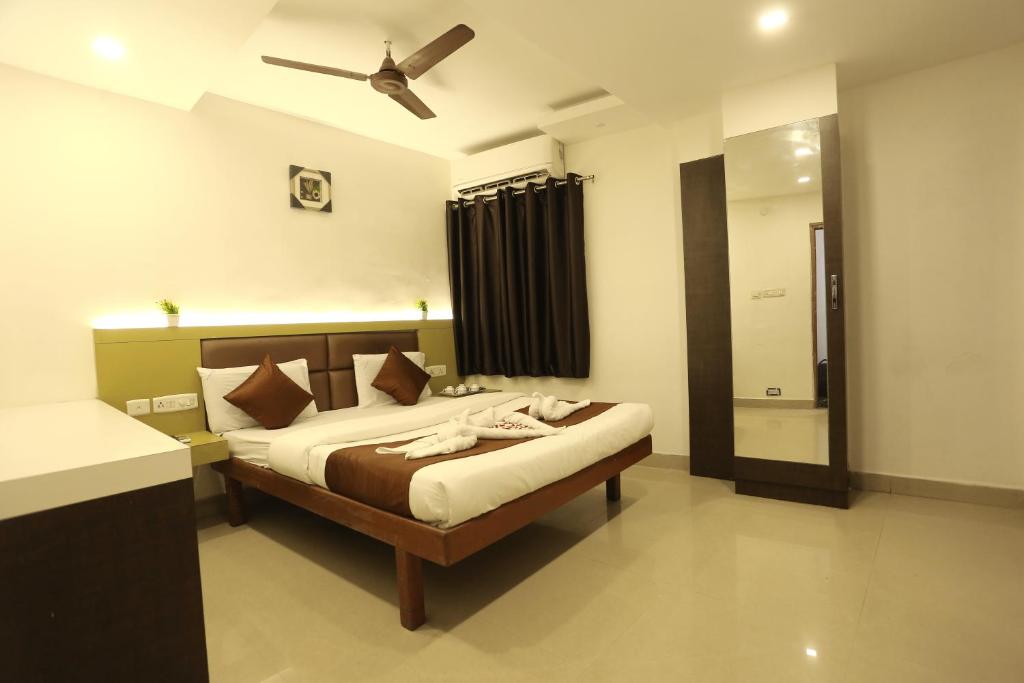 a bedroom with a bed and a ceiling fan at GM Residency in Chennai