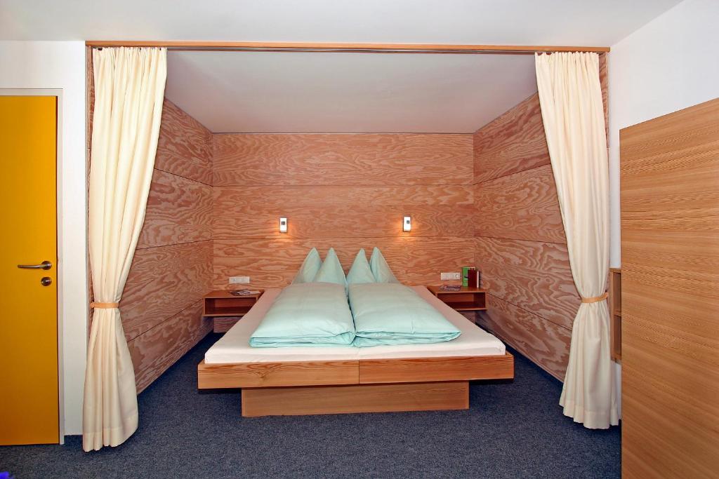 a bedroom with a bed with a canopy at Ferienwohnungen Broser in Obergurgl