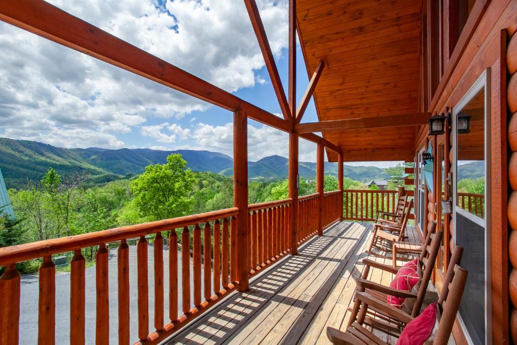 a porch with chairs and a view of mountains at Poolin Around with Private Hot Tub and Indoor Pool in Pigeon Forge