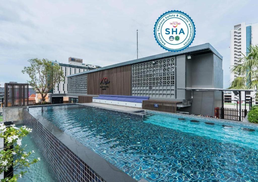 a large swimming pool in front of a building at XQ Pattaya Hotel in Pattaya