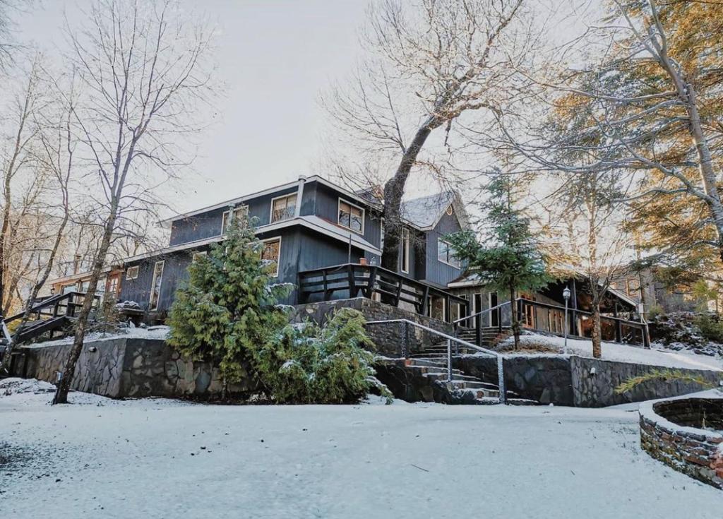 a large house with snow on the ground at Hotel Boutique Anttuy in Las Trancas