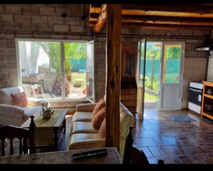 a living room with a couch and a table at Cabañas De Cero in Mercedes