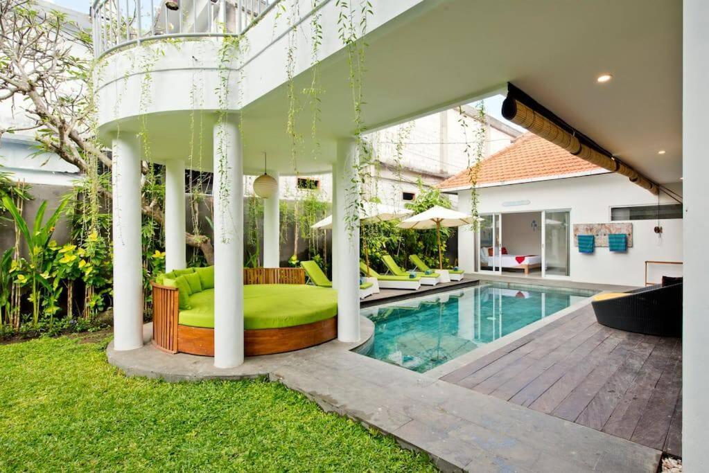 a bedroom in a house with a swimming pool at 3BR Del Mar Beach Villas Near La Plancha Seminyak in Seminyak