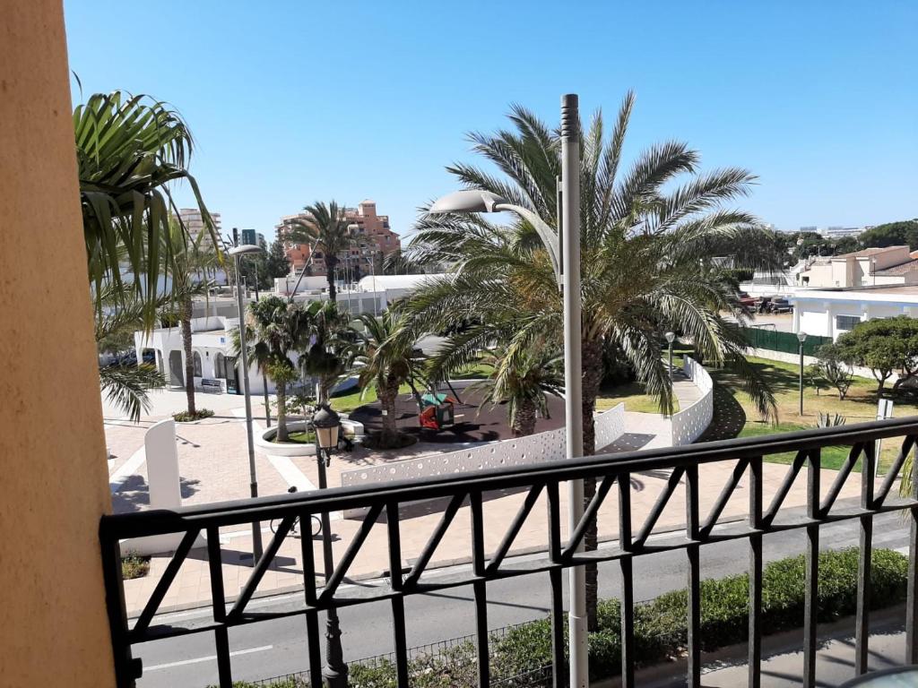 a view from a balcony of a resort with palm trees at Muy buena ubicación, cerca de la playa y céntrico. in Roquetas de Mar