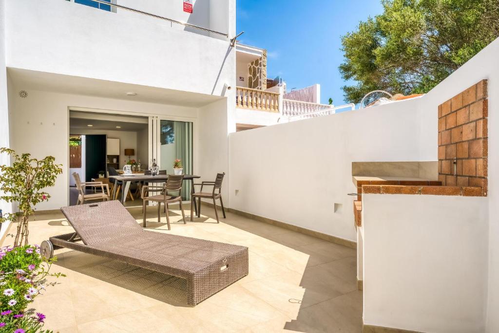 an outdoor patio with a bench and a table at Els Arbocers 131-2 in Cala Blanca
