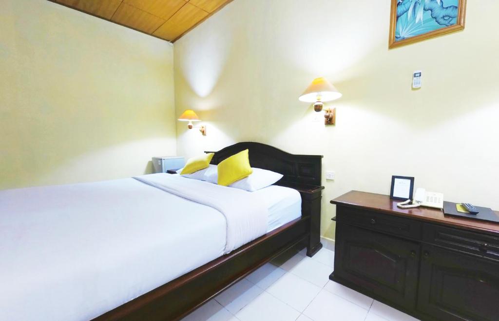 Postel nebo postele na pokoji v ubytování Masainn Hotel Kuta