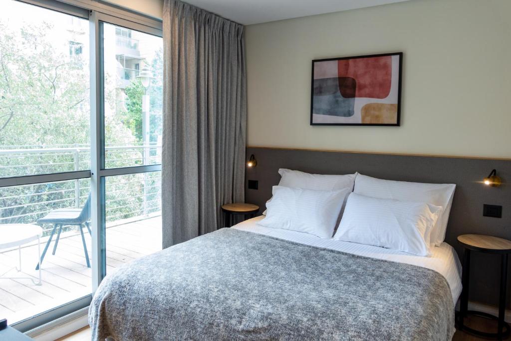 Postel nebo postele na pokoji v ubytování Urbanic Hotel