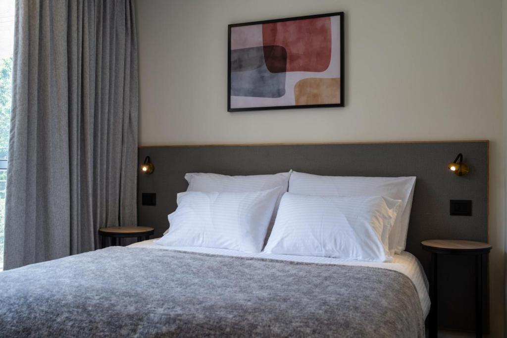 Postel nebo postele na pokoji v ubytování Urbanic Hotel