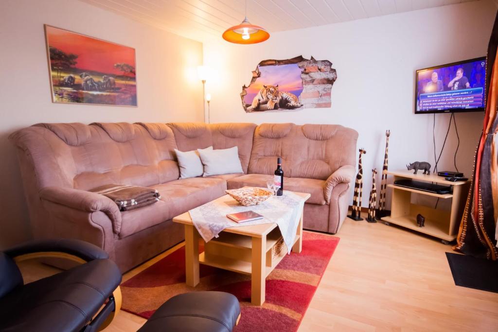 a living room with a couch and a table at Haus-Karin-Ferienwohnung-1 in Büsum