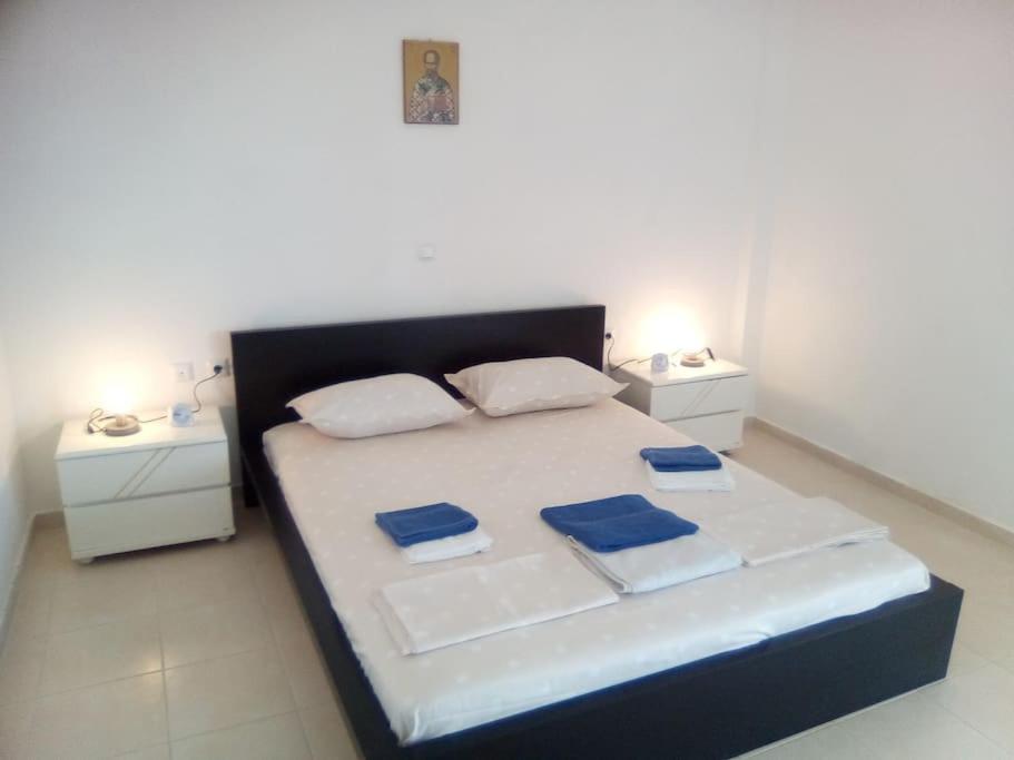 a bedroom with a large bed with two night stands at VILLA S&A MEDITATION in Chalkida
