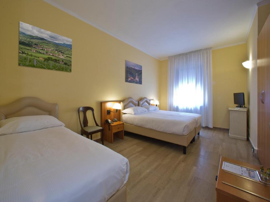 Postel nebo postele na pokoji v ubytování Veronello Resort