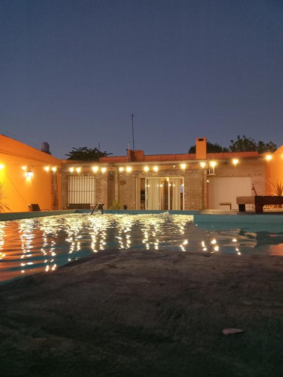 a house with a pool at night with lights at El Destino Casa de Descanso in Tandil