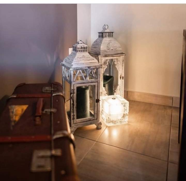 a room with a fireplace and a room with luggage at Villa Konstantinos in Olympiaki Akti