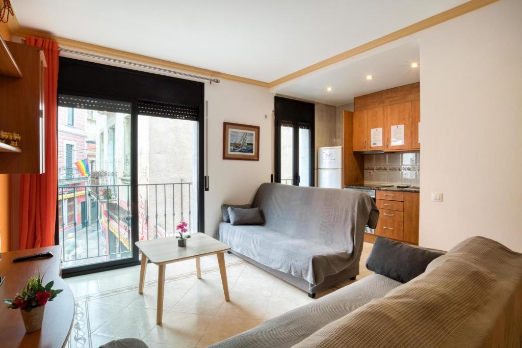 a living room with a couch and a table at Apartament Yaco 2 in Lloret de Mar