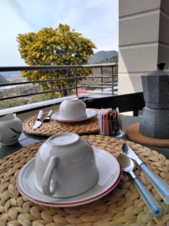 uma mesa com um bule de chá e pratos sobre ele em "Vento di Levante Suite" , nuova struttura in collina em Casarza Ligure