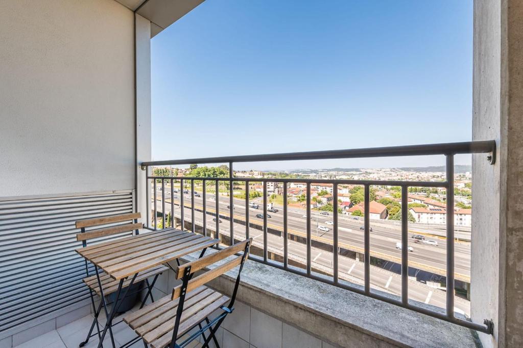 - un balcon avec deux bancs et une vue sur la rue dans l'établissement Dragon Stadium Studio w Balcony by LovelyStay, à Porto