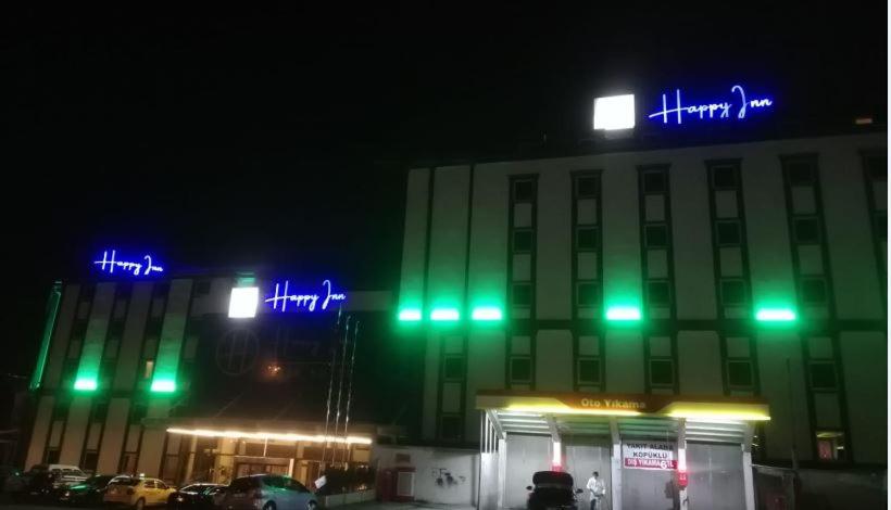 a building with green and blue lights in front of it at Happy Inn Gebze Hotel in Kocaeli