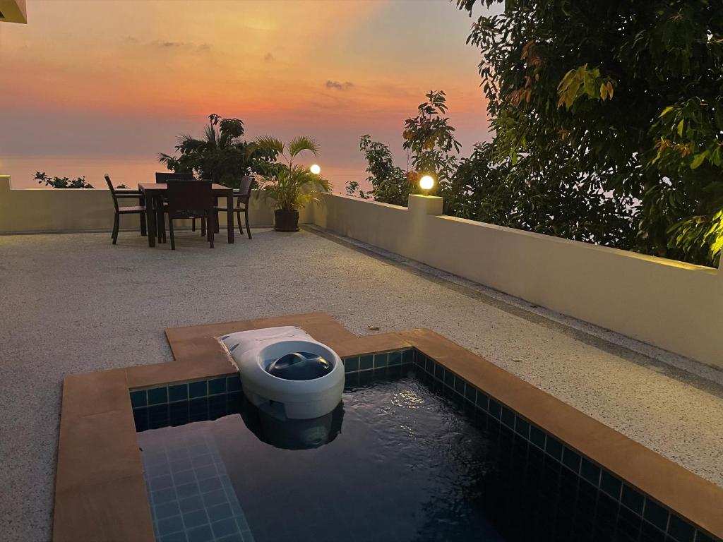 a toilet sitting in a pool of water on a patio at KohTao Studios Sunset in Koh Tao