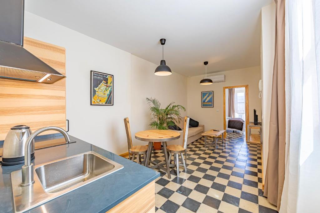 a kitchen with a sink and a table in a room at New Use Pz España 3 izquierda in Cádiz