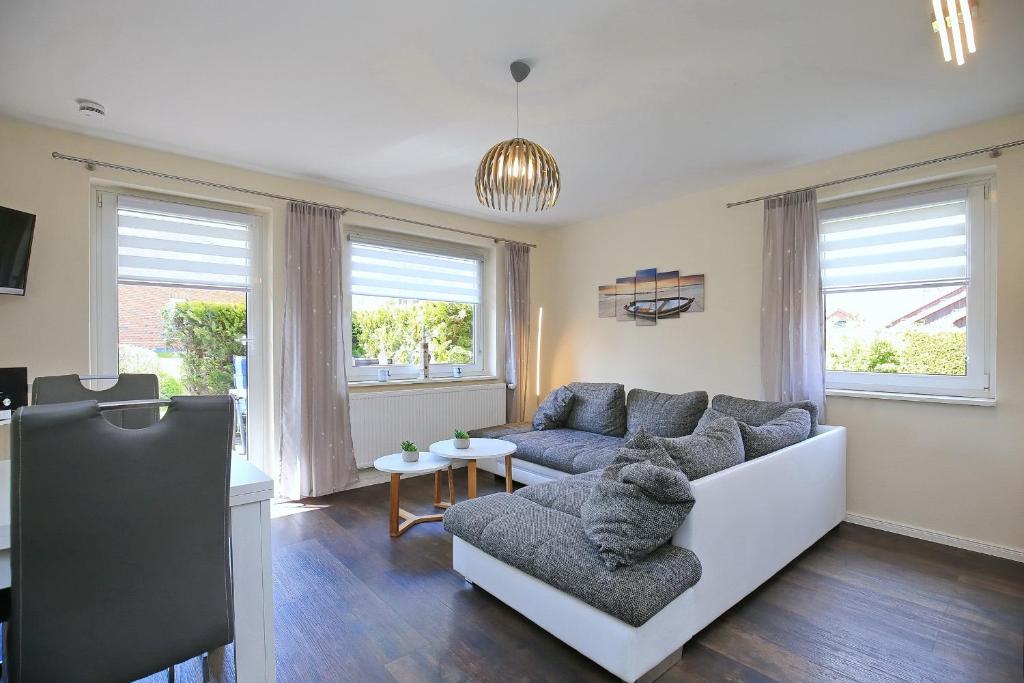 a living room with a couch and a table at Urlauberdorf Haus 63d in Boltenhagen