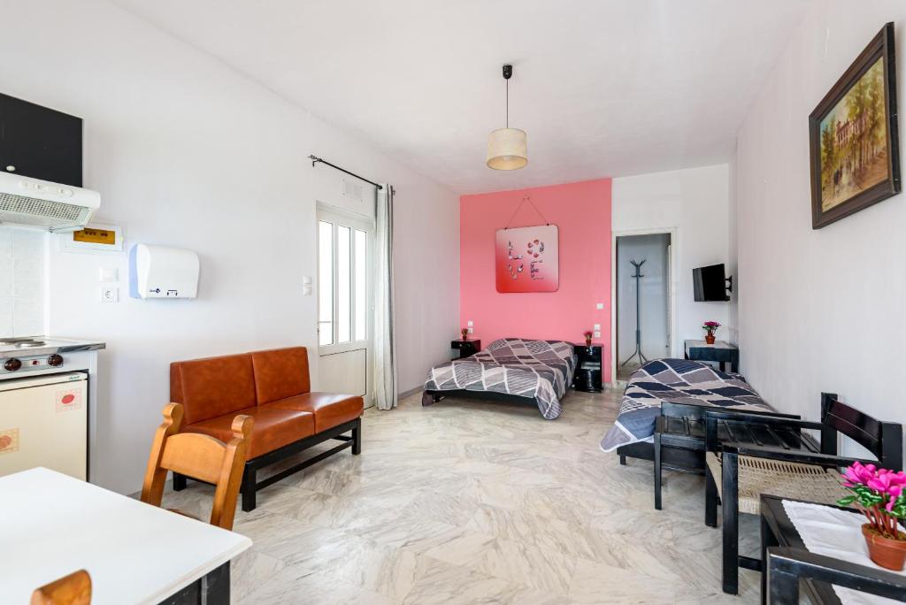 a living room with a couch and a table at Angela Apartments new listing in Marathi
