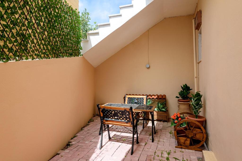 a patio with a table and chairs on a wall at Angela Apartments new listing in Marathi