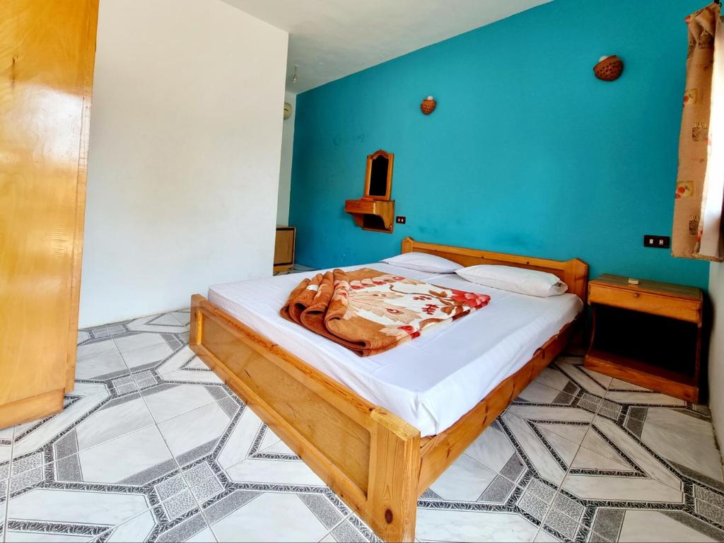 Postel nebo postele na pokoji v ubytování Jowhara Hotel