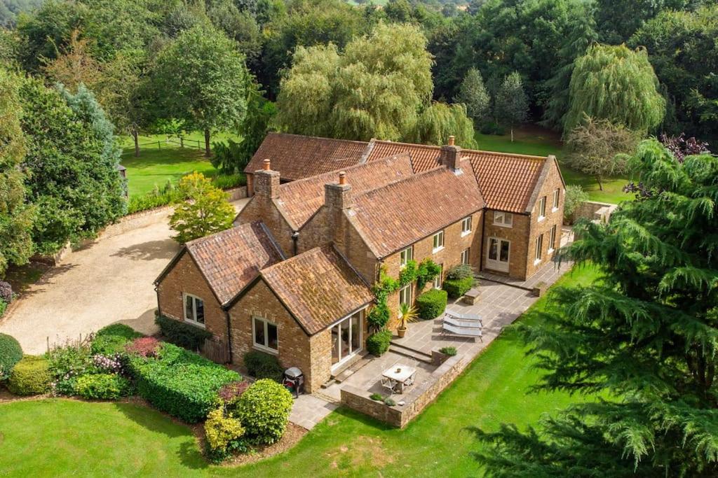 an aerial view of a large brick house at Stunning Country Farm House between Bristol & Bath in Bristol