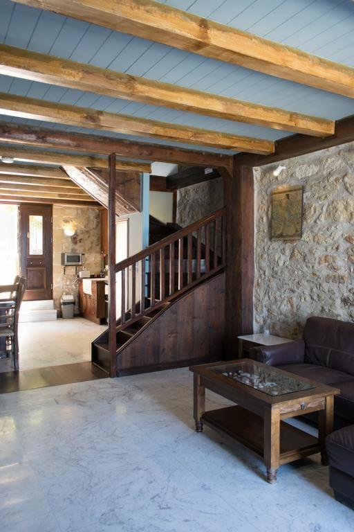 a living room with a couch and a table at Volakas Beachfront Suites in Rethymno