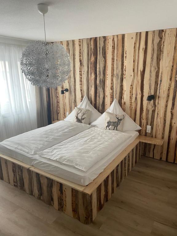 a large bed in a bedroom with a chandelier at Ferienwohnung Röck in Hornberg