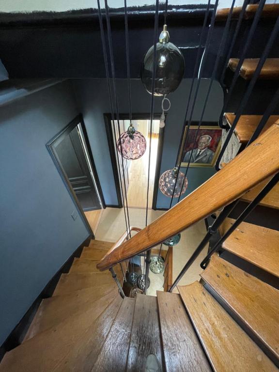 an overhead view of a staircase with pendant lights at Gîte les Remparts in Pierrefonds