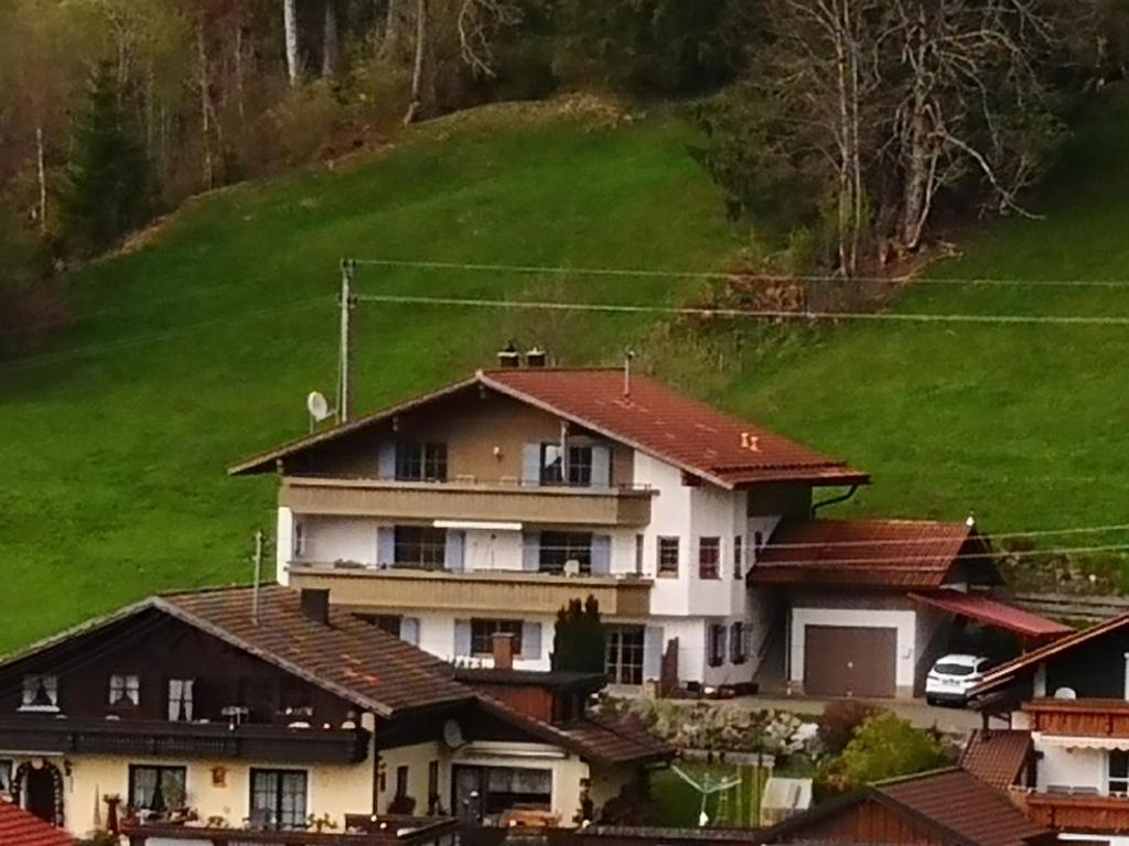 a large white house with red roof at Jungholz Erlebnis in Jungholz