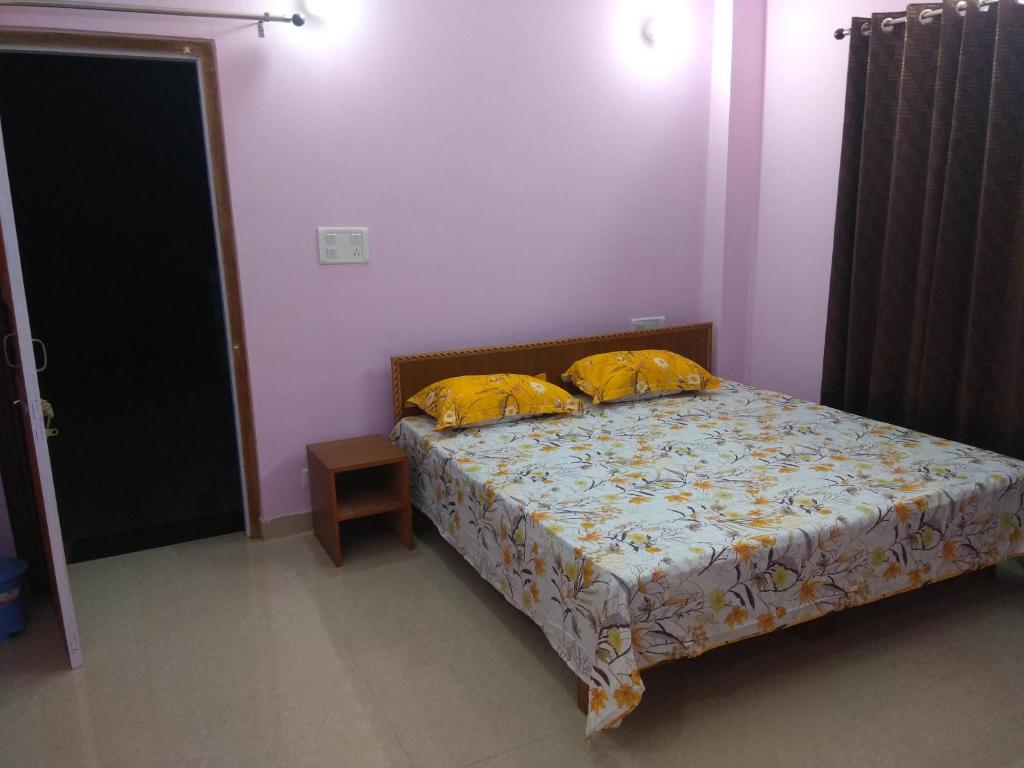 a bedroom with a bed with two yellow pillows at A.R . Homestay in Shimla