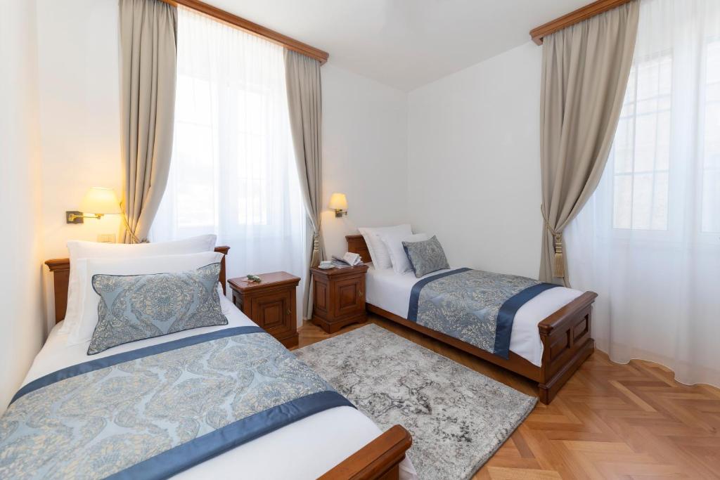 Postel nebo postele na pokoji v ubytování Heritage Hotel Tisno