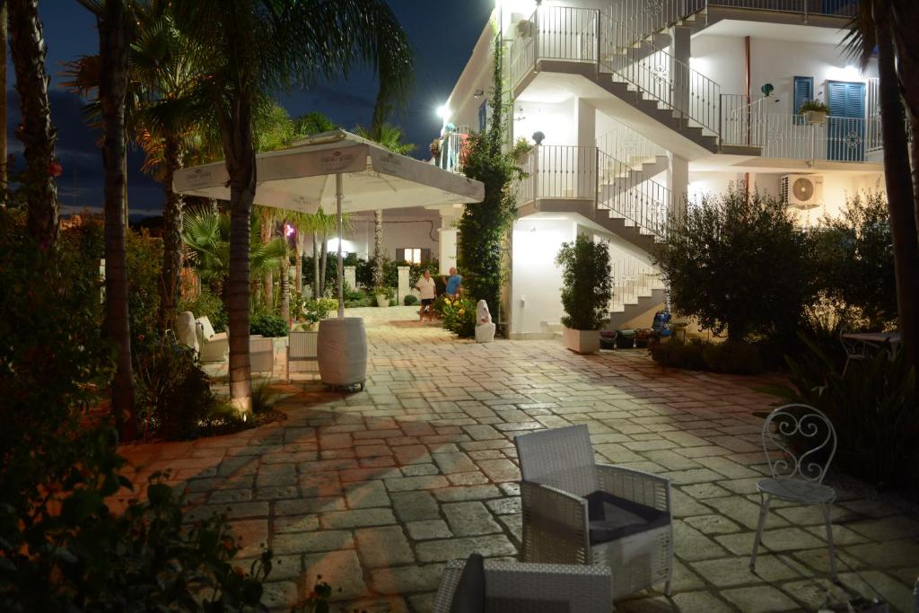 a walkway in front of a building at night at B&B LA COLIMENA in Torre Colimena