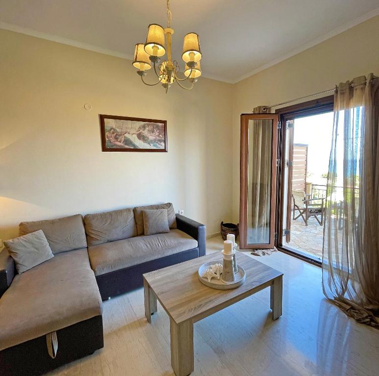 een woonkamer met een bank en een tafel bij Kimata Sea View Apartment in Argassi