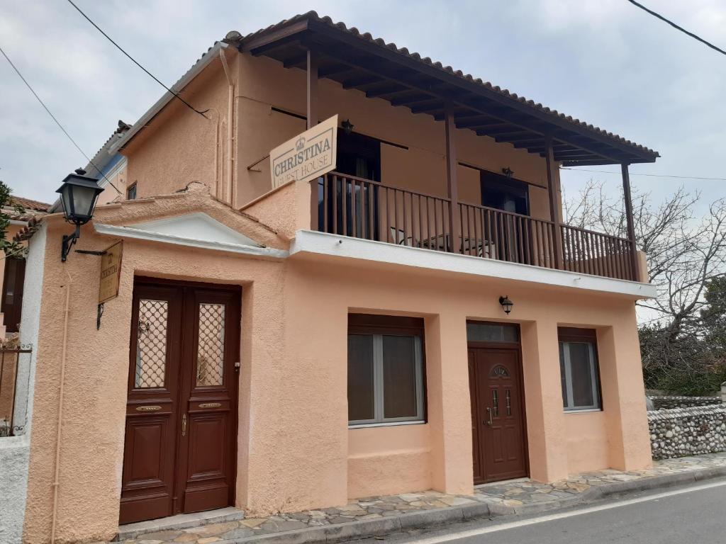 a small house with a balcony on top of it at Christina Guest House in Mystras