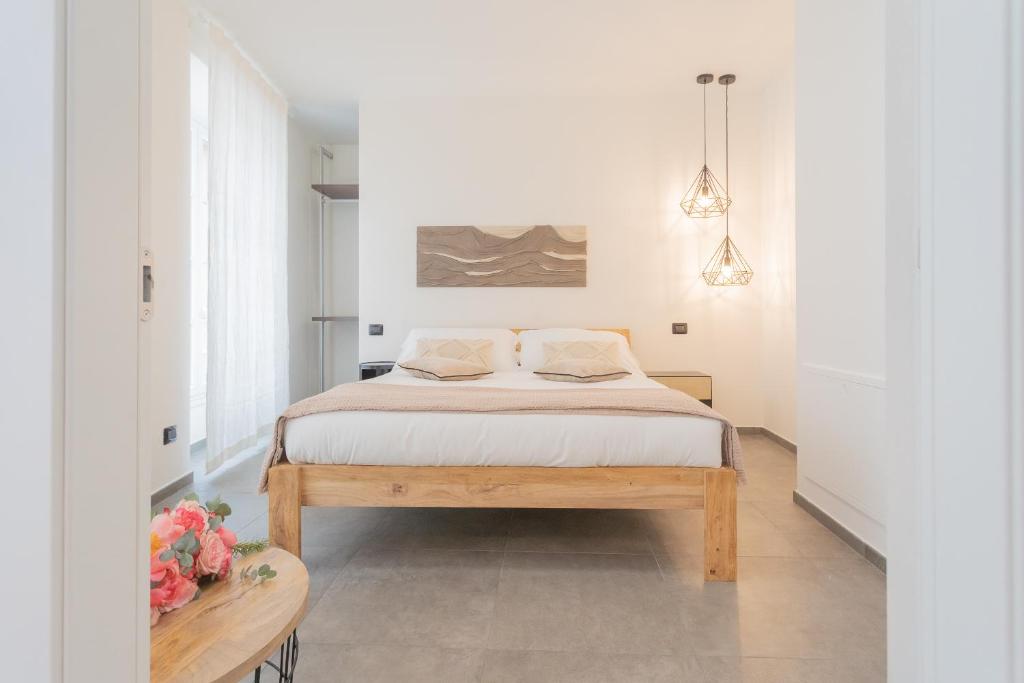 a bedroom with a bed and a table at Enchanted Como Lake - City Apartment by Rent All Como in Como
