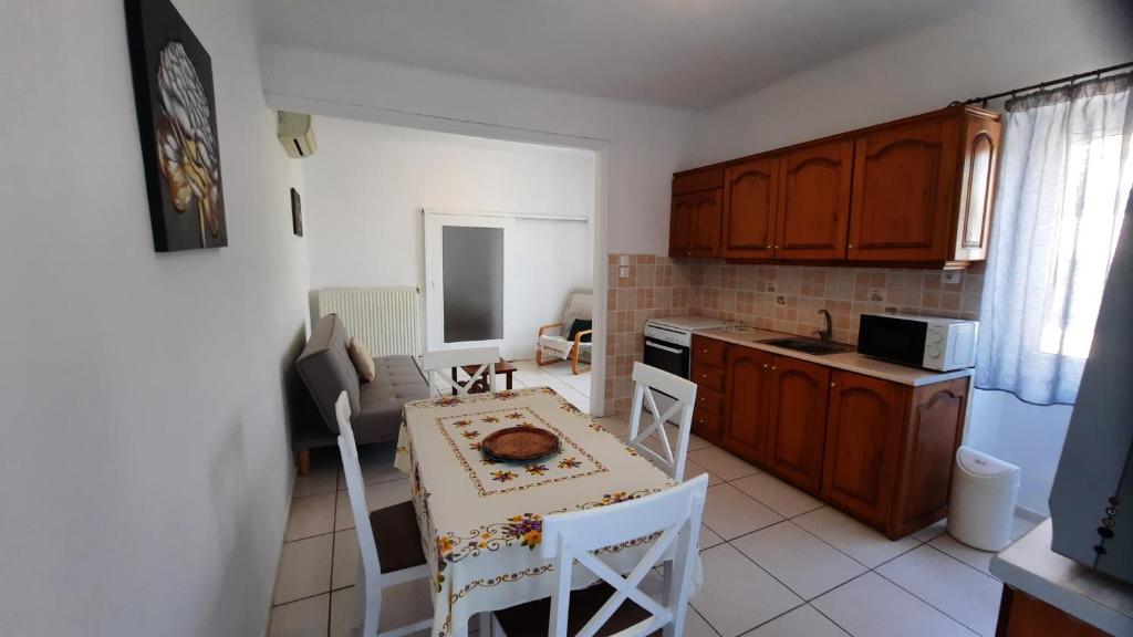 a kitchen with a table and chairs in a room at Aegina house1 in Aegina Town